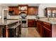 Well-equipped kitchen featuring stainless steel appliances, dark wood cabinets, and granite countertops at 7743 Camelback Dr, Indianapolis, IN 46250