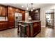 Open kitchen featuring a large island, stainless steel appliances, and dark wood cabinets at 7743 Camelback Dr, Indianapolis, IN 46250