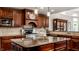 Kitchen with a large island, stainless steel appliances, and custom dark wood cabinetry at 7743 Camelback Dr, Indianapolis, IN 46250