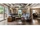 Bright living room with backyard access, coffered ceilings, and built-in bookshelves at 7743 Camelback Dr, Indianapolis, IN 46250