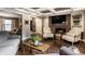 Comfortable living room with a brick fireplace, coffered ceilings, and hardwood floors at 7743 Camelback Dr, Indianapolis, IN 46250