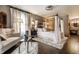 Comfortable main bedroom with four-poster bed, sitting area, and shag rug on hardwood floors at 7743 Camelback Dr, Indianapolis, IN 46250