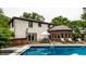 Stunning backyard pool area with an outdoor dining set and sun loungers at 7743 Camelback Dr, Indianapolis, IN 46250