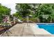 Outdoor pool area with patio seating, flower planters, and a basketball hoop, offering a relaxing, fun atmosphere at 7743 Camelback Dr, Indianapolis, IN 46250