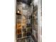 A tile shower with a glass door and slate-style walls in multiple neutral colors, offering a modern and stylish design at 7743 Camelback Dr, Indianapolis, IN 46250