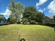 Lush green backyard and mature trees create a serene outdoor space at 815 N 12Th St, Elwood, IN 46036