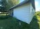 The back of the vintage home features wood siding and a small porch with a wood railing at 815 N 12Th St, Elwood, IN 46036