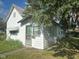 Charming vintage home featuring wood siding, covered windows, and a classic screen door entrance at 815 N 12Th St, Elwood, IN 46036