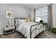 Cozy bedroom featuring a metal frame bed, soft carpet, and a dedicated workspace near a bright window at 8568 Goldfinch Rd, Brownsburg, IN 46112