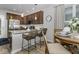 Modern kitchen features stainless steel appliances, granite counters, and a breakfast bar with barstool seating at 8568 Goldfinch Rd, Brownsburg, IN 46112
