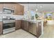 Well-lit kitchen with stainless steel appliances, granite counters, and seamless access to the dining and living areas at 8568 Goldfinch Rd, Brownsburg, IN 46112