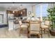 Stylish kitchen features stainless steel appliances, granite counters, a breakfast bar and an adjacent dining area at 8568 Goldfinch Rd, Brownsburg, IN 46112