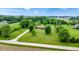 An elevated perspective showcasing a residence surrounded by verdant landscaping and a long private drive at 8818 Mathews Rd, Indianapolis, IN 46259