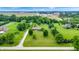Expansive aerial view of the home and property showcasing mature trees and manicured lawns at 8818 Mathews Rd, Indianapolis, IN 46259