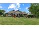Expansive backyard with well-maintained lawn, mature trees, and patio area at 8818 Mathews Rd, Indianapolis, IN 46259