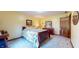 Comfortable bedroom with a floral bedspread and matching furniture at 8818 Mathews Rd, Indianapolis, IN 46259