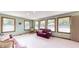 Bright bonus room with neutral colored walls, multiple windows, and comfortable seating at 8818 Mathews Rd, Indianapolis, IN 46259