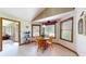 Cozy dining area featuring natural light from multiple windows, wood-trimmed windows and a classic table set at 8818 Mathews Rd, Indianapolis, IN 46259