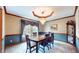 Elegant dining room featuring a chandelier, wood trim, and a large window with natural light at 8818 Mathews Rd, Indianapolis, IN 46259