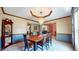 Elegant dining room with a wood table, chandelier, and half wall under the chair rail at 8818 Mathews Rd, Indianapolis, IN 46259