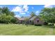 Charming brick home with manicured lawn, mature trees, and beautiful landscaping at 8818 Mathews Rd, Indianapolis, IN 46259