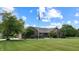 Picture of the front exterior of a brick home with landscaped yard and an American flag at 8818 Mathews Rd, Indianapolis, IN 46259