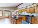 Bright eat-in kitchen with wooden cabinets, granite countertops, an island, and stainless steel appliances at 8818 Mathews Rd, Indianapolis, IN 46259