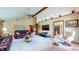 Inviting living room featuring vaulted ceilings, a ceiling fan, a leather sofa set, and neutral carpeting at 8818 Mathews Rd, Indianapolis, IN 46259