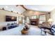 Comfortable living room with a fireplace, a large window, vaulted ceilings, and a leather sofa at 8818 Mathews Rd, Indianapolis, IN 46259