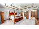 Charming main bedroom featuring a four-poster bed, tray ceiling, and open access to the walk-in closet at 8818 Mathews Rd, Indianapolis, IN 46259