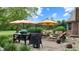 Inviting patio with comfortable seating, shade umbrellas, and outdoor cooking area at 8818 Mathews Rd, Indianapolis, IN 46259