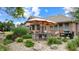 Inviting patio area with outdoor dining set, umbrella, grill, and attractive landscaping at 8818 Mathews Rd, Indianapolis, IN 46259