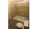 Cozy bathroom with cream tile walls, a white bathtub and toilet, with classic fixtures at 8875 N Goat Hollow Rd, Mooresville, IN 46158