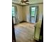 Bedroom featuring hardwood floors, two windows with curtains, and a ceiling fan at 8875 N Goat Hollow Rd, Mooresville, IN 46158