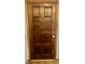Elegant wooden front door with classic panel design and shiny brass hardware at 8875 N Goat Hollow Rd, Mooresville, IN 46158
