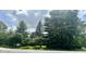 View of the front yard with a home nestled among mature trees at 8875 N Goat Hollow Rd, Mooresville, IN 46158