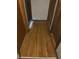 Hallway with hardwood flooring featuring multiple doors at 8875 N Goat Hollow Rd, Mooresville, IN 46158