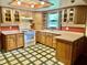 Well-lit kitchen with wooden cabinets, green-patterned tile flooring and neutral countertops at 8875 N Goat Hollow Rd, Mooresville, IN 46158
