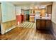 A kitchen with wooden cabinets, an electric range, and a unique tile floor at 8875 N Goat Hollow Rd, Mooresville, IN 46158