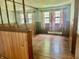 Cozy living room with wood floors, wood paneling and large windows at 8875 N Goat Hollow Rd, Mooresville, IN 46158