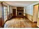 Open living room with brick fireplace and wood paneling, creating a cozy and inviting space at 8875 N Goat Hollow Rd, Mooresville, IN 46158