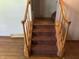Carpeted staircase with wood railing, leading to an upper level at 8875 N Goat Hollow Rd, Mooresville, IN 46158