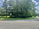 Street view showing the yard and mature trees lining the property at 8875 N Goat Hollow Rd, Mooresville, IN 46158