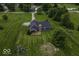 Overhead view of a home, showing spacious grassy backyard with play set, fenced perimeter, and large trees at 911 Centennial Rd, Martinsville, IN 46151