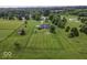 Estate home with large, fenced yard, mature trees, outbuilding, and play set at 911 Centennial Rd, Martinsville, IN 46151