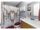 Charming bathroom featuring a vanity, toilet, shower with unique shower curtain and coordinated decor accents at 911 Centennial Rd, Martinsville, IN 46151