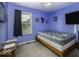 Comfortable bedroom with window, TV, and blue walls, offering a cozy and inviting space at 911 Centennial Rd, Martinsville, IN 46151