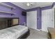 Bedroom featuring neutral carpet, a double bed, and ample closet space, providing a cozy and practical retreat at 911 Centennial Rd, Martinsville, IN 46151