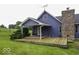 Charming blue home featuring a spacious wooden deck and a classic brick chimney at 911 Centennial Rd, Martinsville, IN 46151