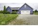 Lovely blue home with a two-car garage, a statue on the lawn, and a long gravel driveway at 911 Centennial Rd, Martinsville, IN 46151